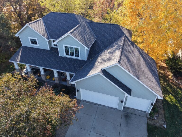 Large house with autumn trees surrounding
